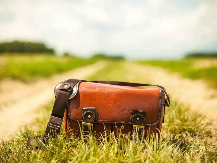 Brown leather satchel on a country lane