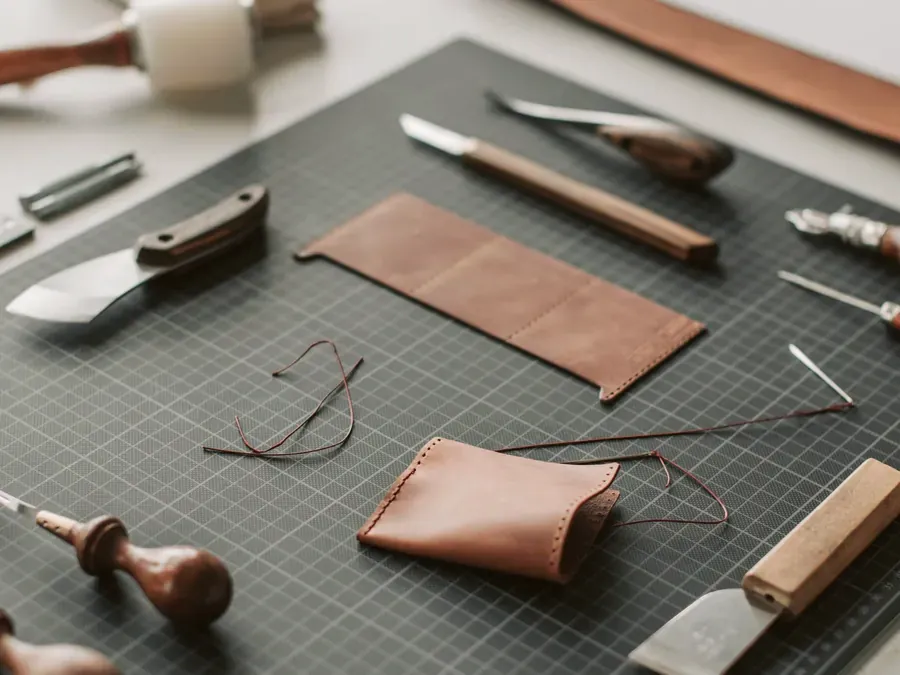 Leather and hand tools on a workshop bench