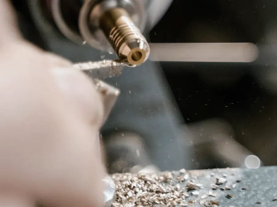 Brass component being shaped on a lathe