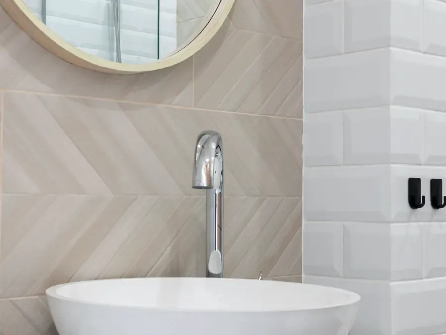 Chrome faucet and vessel basin on a marble vanity